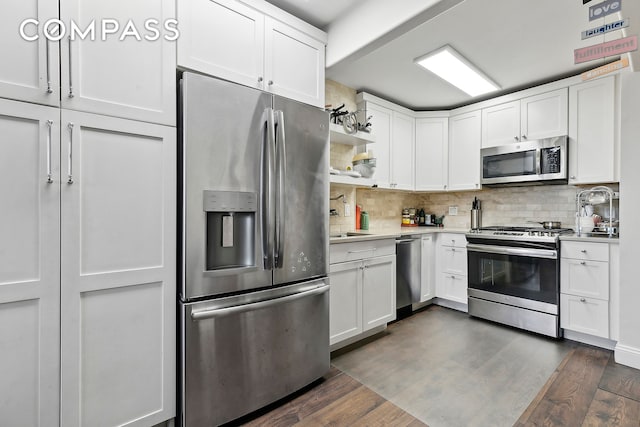 200 Rector Pl Unit 26B, New York City, NY 10280 - kitchen with appliances with stainless steel finishes, light countertops, open shelves, white cabinetry, and backsplash
