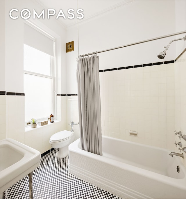 full bath featuring tile walls, toilet, shower / bath combo with shower curtain, and ornamental molding