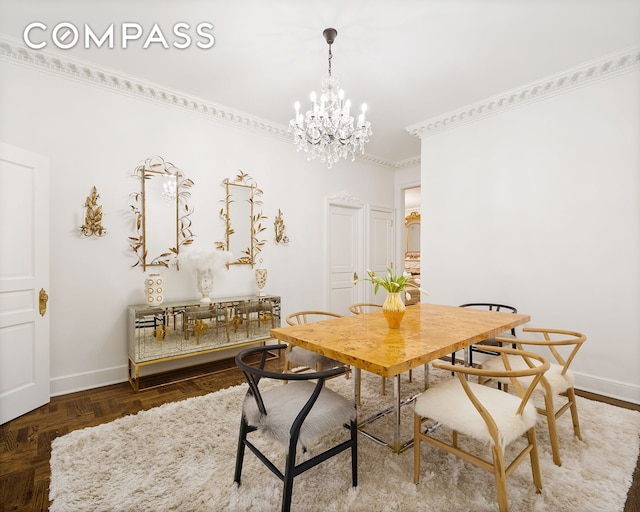 dining space featuring baseboards, a chandelier, and ornamental molding