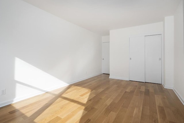 unfurnished bedroom featuring hardwood / wood-style flooring