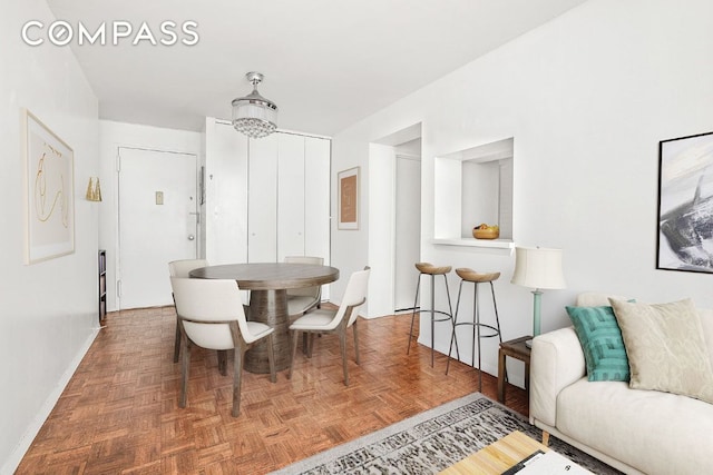 dining space with dark parquet floors