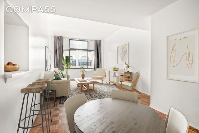 living area featuring parquet flooring