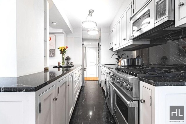 kitchen with marble finish floor, a sink, white cabinetry, stainless steel appliances, and decorative backsplash