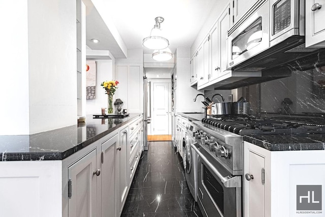 kitchen with marble finish floor, a sink, tasteful backsplash, appliances with stainless steel finishes, and white cabinets