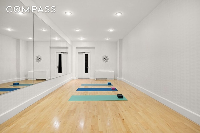 workout room with wood-type flooring