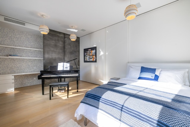 bedroom featuring light wood-type flooring and visible vents