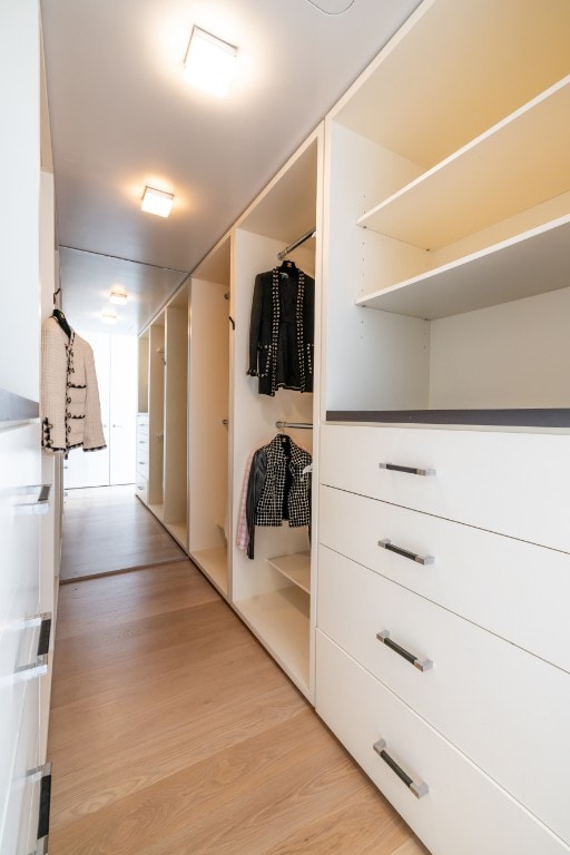 walk in closet featuring light hardwood / wood-style floors