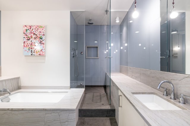 bathroom with vanity and a shower with door