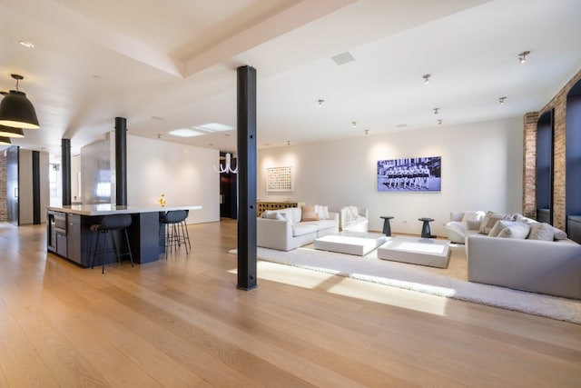 living area featuring light wood finished floors and visible vents