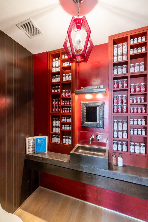 bar with visible vents, a sink, and wood walls