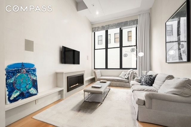 living room with a fireplace and wood finished floors