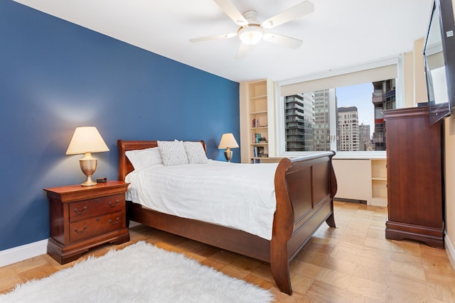 bedroom featuring baseboards and ceiling fan