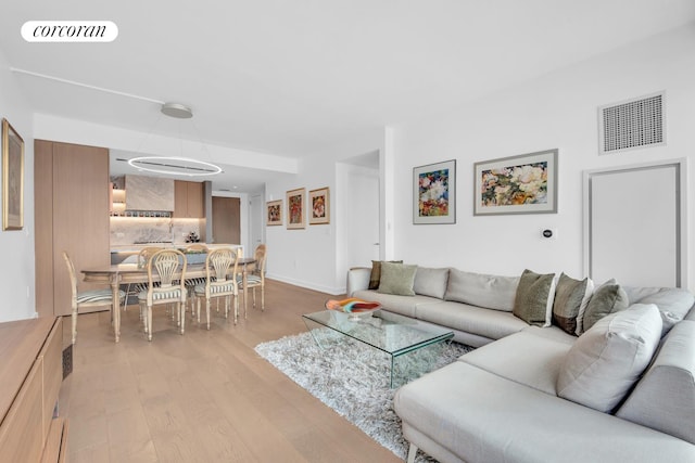 living room with light wood-style floors and baseboards