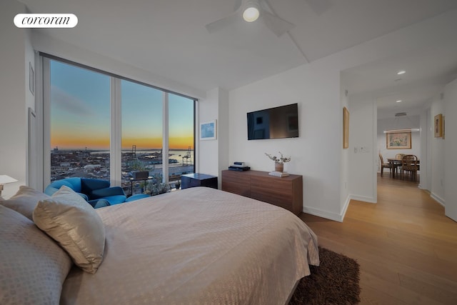 bedroom featuring light wood-style floors, a ceiling fan, recessed lighting, and baseboards