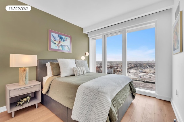 bedroom with light wood-style floors and baseboards
