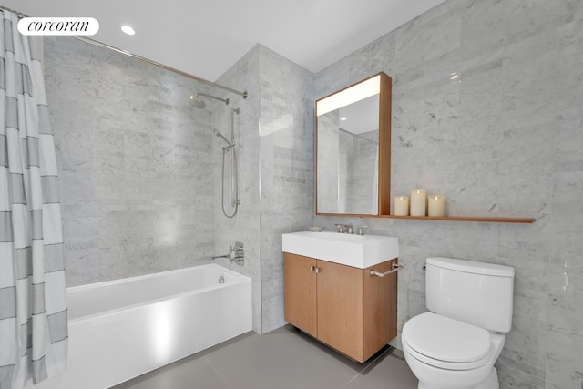 full bathroom with shower / bath combination with curtain, vanity, toilet, and tile walls