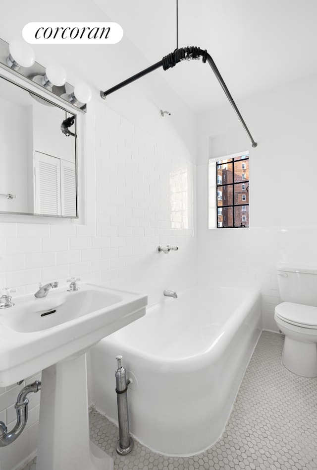 full bathroom with toilet, tile patterned flooring, tile walls, and shower / bathtub combination