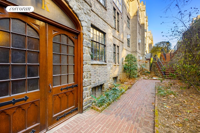 view of exterior entry with brick siding