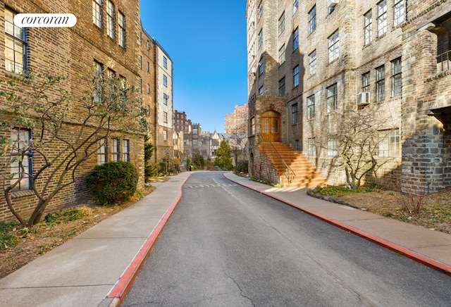 view of street featuring stairway, curbs, and sidewalks