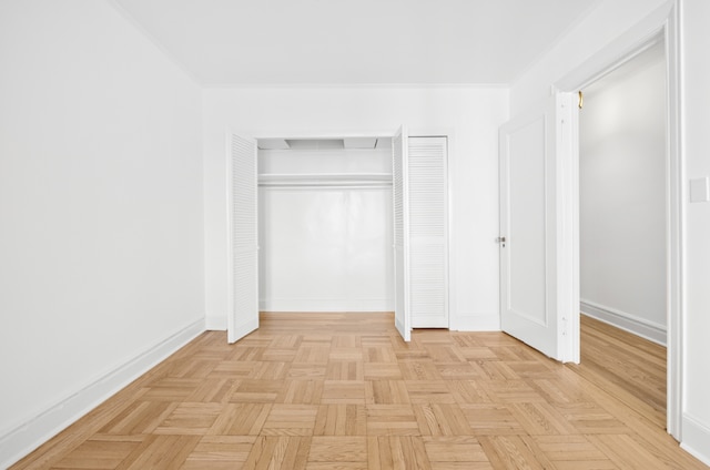 unfurnished bedroom with crown molding and light parquet floors