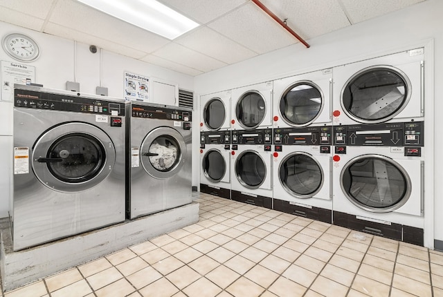 laundry area featuring light tile patterned floors, washer and dryer, and stacked washer / dryer