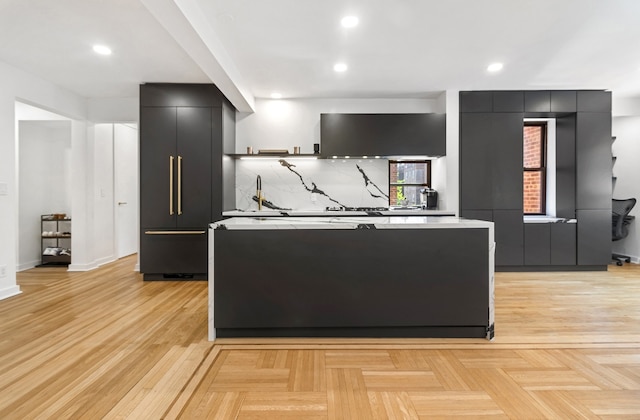 kitchen with light parquet floors, a kitchen island, and backsplash