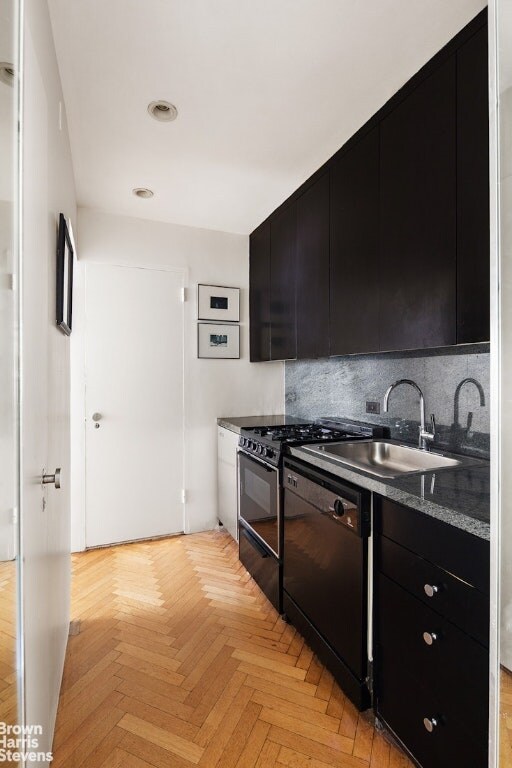 kitchen featuring backsplash, black appliances, sink, and light parquet floors