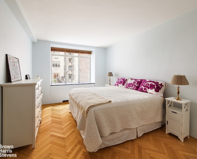 bedroom with light parquet floors