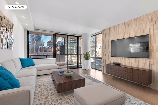 living room featuring expansive windows and light wood-type flooring