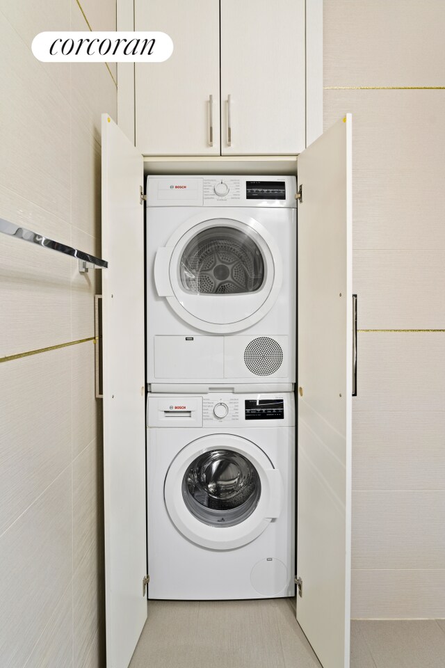 clothes washing area with stacked washer / drying machine
