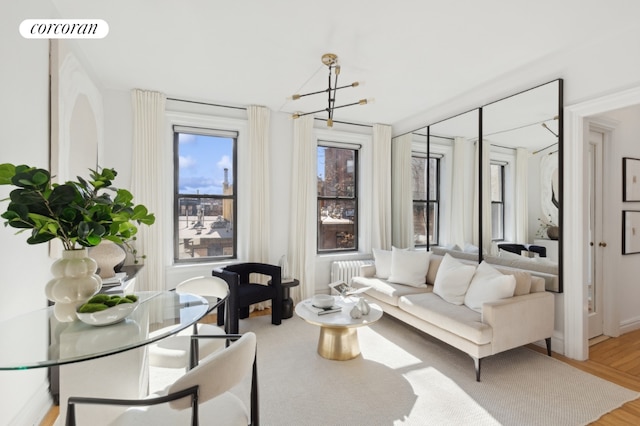 living room featuring hardwood / wood-style floors and a notable chandelier