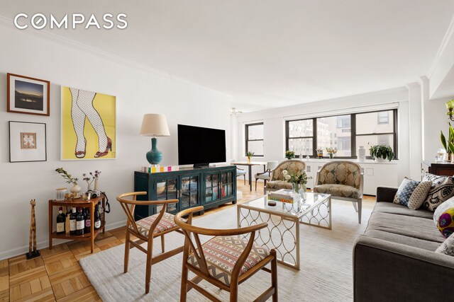 living room with light parquet flooring and crown molding