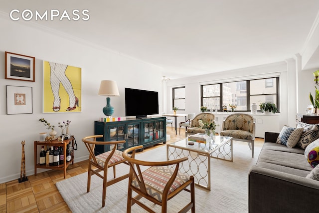 living room with crown molding and baseboards