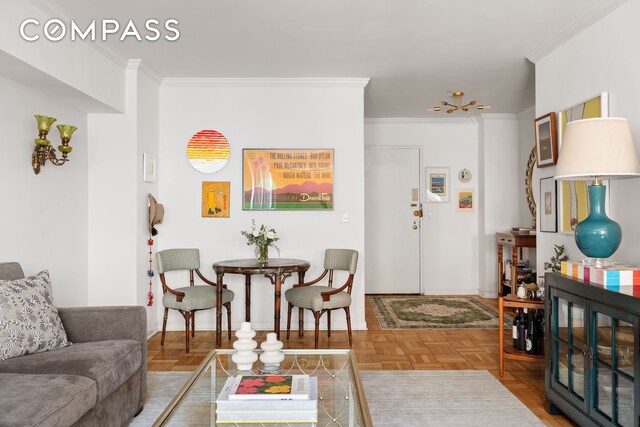 living room with ornamental molding and parquet floors