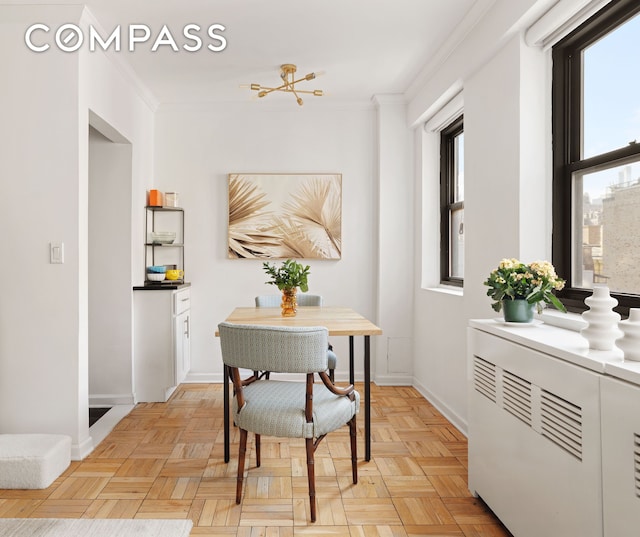 dining room with baseboards and ornamental molding