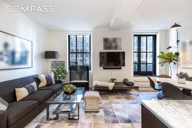 living room featuring beam ceiling