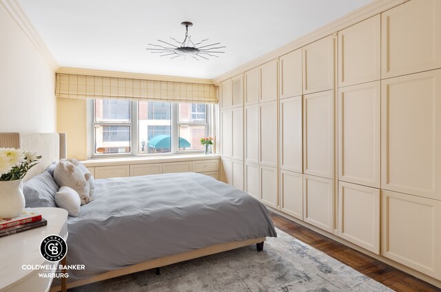 bedroom with crown molding and dark wood-type flooring