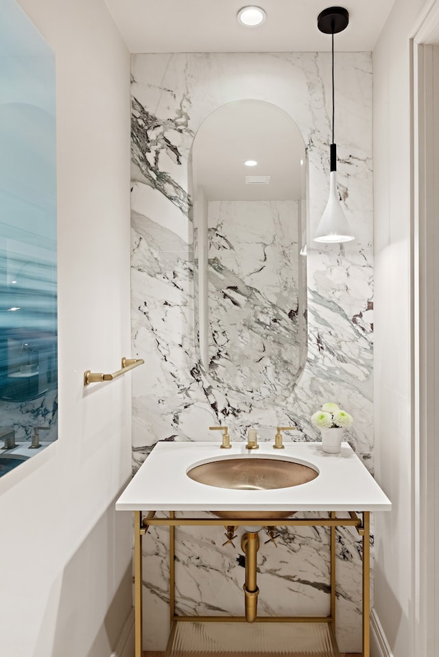 bathroom with stone wall and vanity