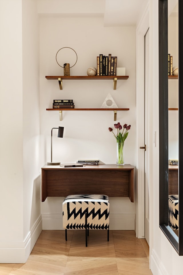 home office with baseboards and light wood finished floors