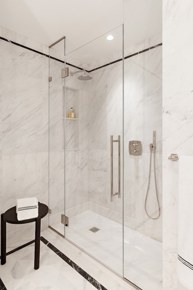 bathroom featuring recessed lighting and a marble finish shower