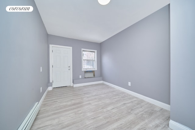 foyer entrance featuring light wood-type flooring and baseboard heating