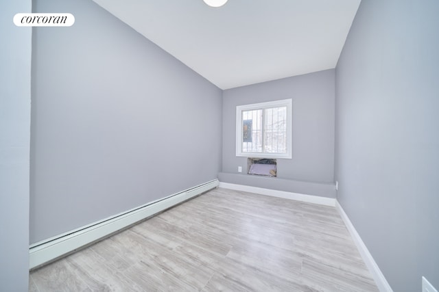 spare room with light hardwood / wood-style flooring and a baseboard radiator