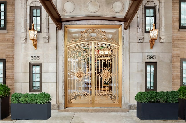entrance to property with stone siding and a gate