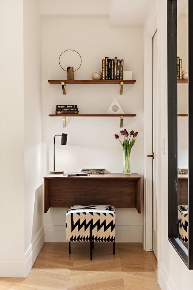 home office featuring light wood-style flooring and baseboards