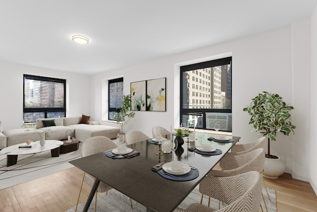 dining area with a wealth of natural light and light hardwood / wood-style floors