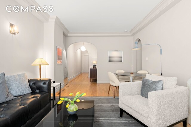 living room featuring crown molding and wood-type flooring