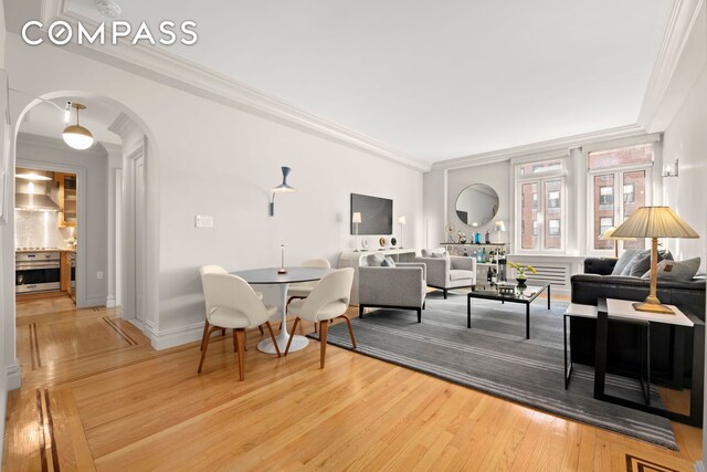 living room featuring crown molding and hardwood / wood-style floors