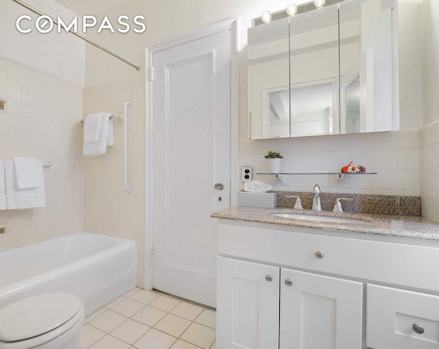 full bathroom featuring vanity, tile patterned flooring, bathtub / shower combination, toilet, and tasteful backsplash