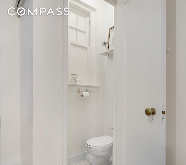 bathroom with tile patterned floors and toilet