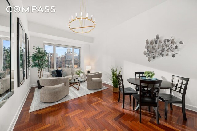 living room with dark parquet flooring and a chandelier